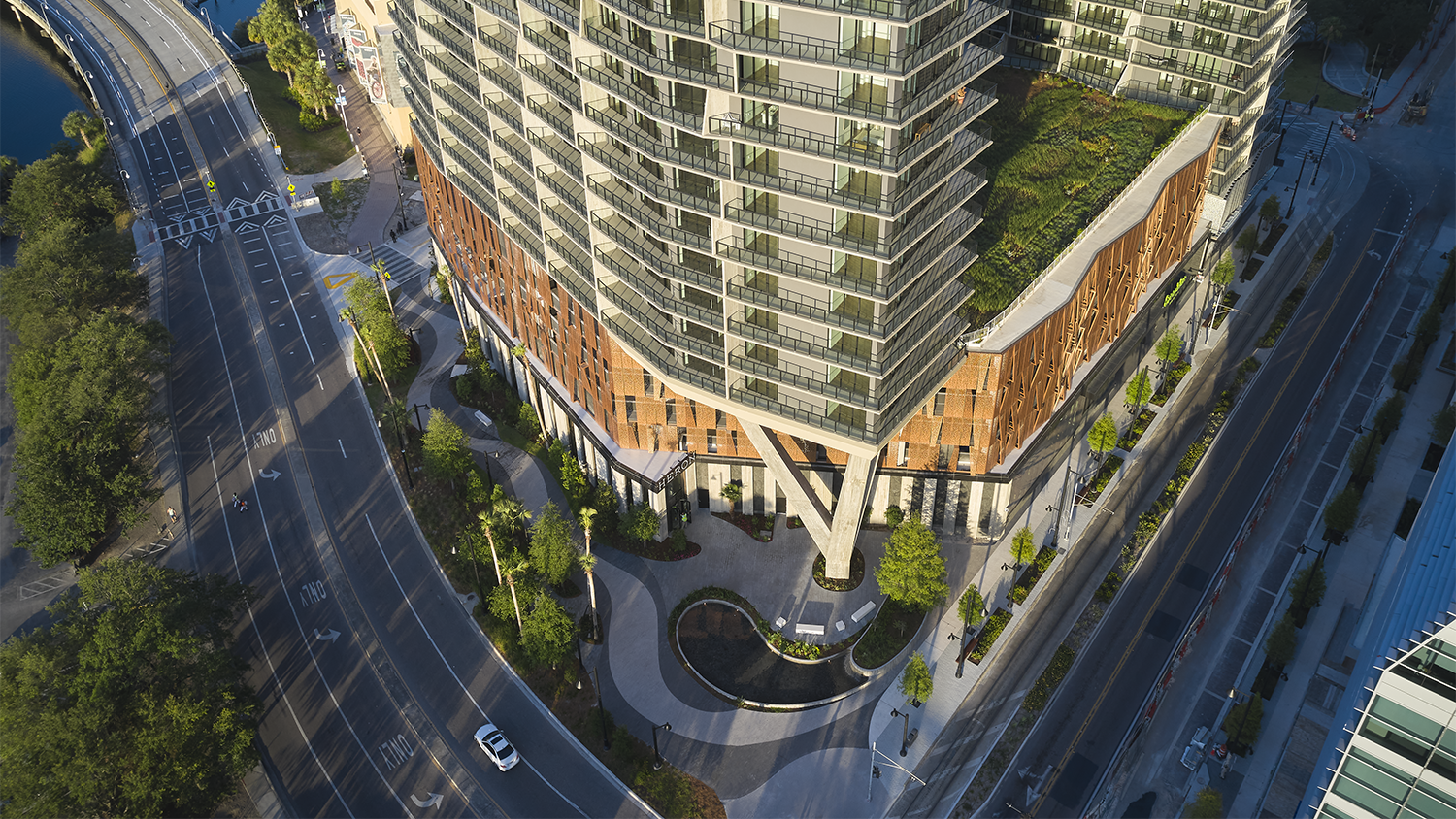 A view of Heron's geometric facade and green roof in Water Street Tampa