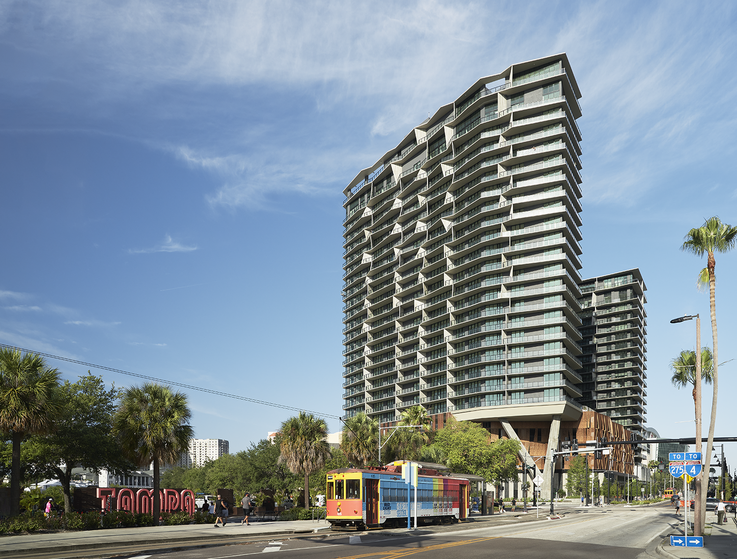 Heron residences on a sunny day with the teco streetcar and pedestrians on the street below